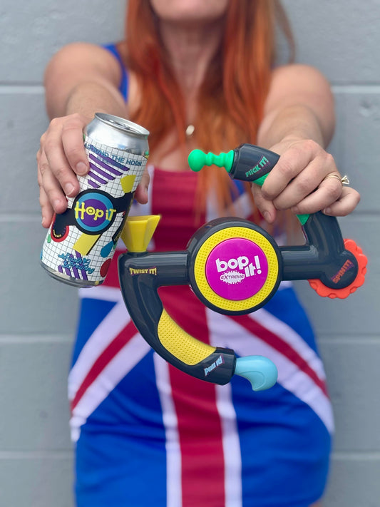A can of Hop It with a Bop It! toy held by someone dressed up as Ginger Spice from the Spice Girls